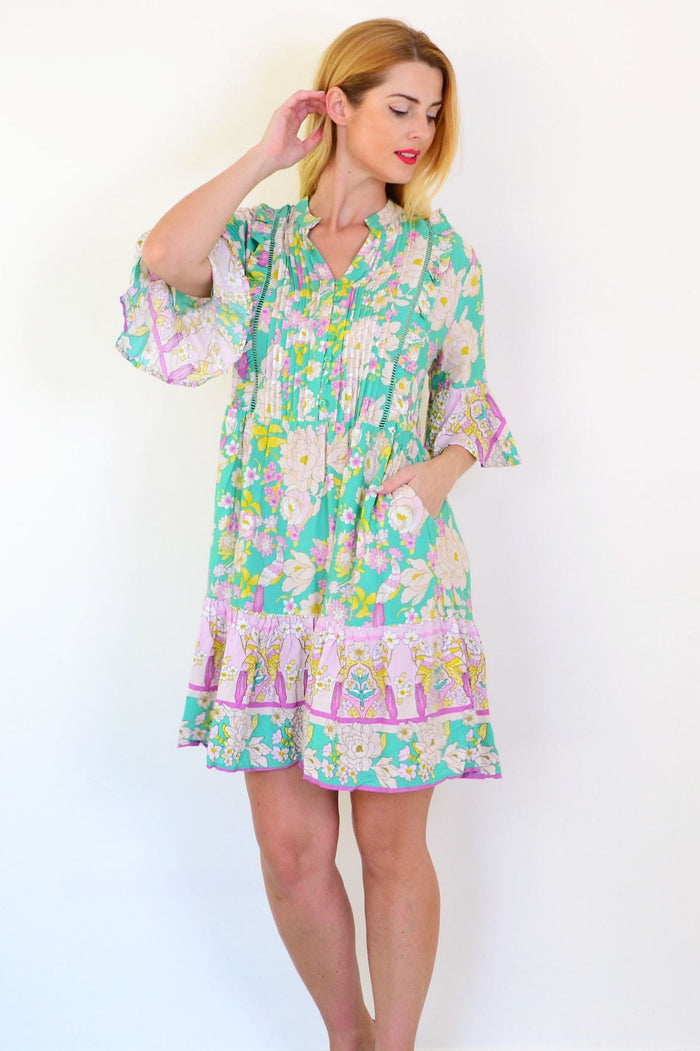 Green floral print bohemian tunic dress by Dream featuring a flowy silhouette and vibrant floral patterns.
