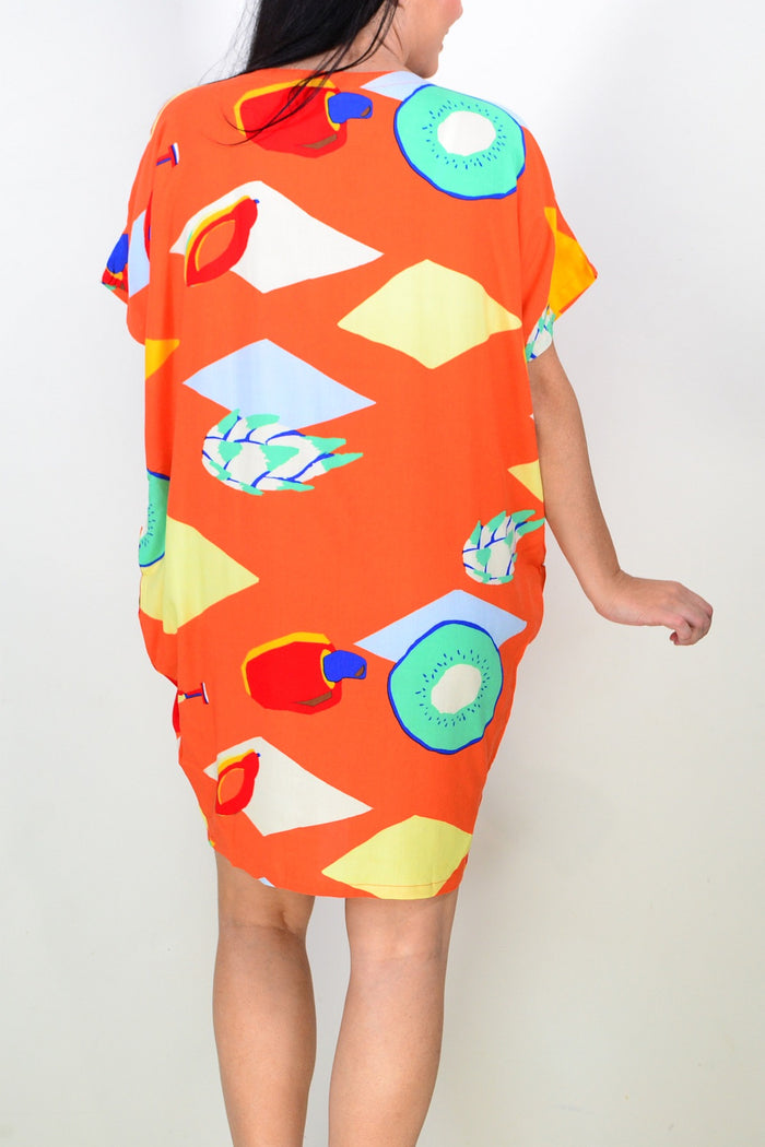 Orange Candy Lane tunic dress by Red Lotus, shown hanging on a mannequin with a relaxed fit and vibrant color.