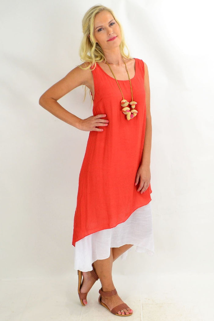 Rust asymmetrical hem Missy Q tunic dress displayed on a hanger with flowing fabric and stylish design details.