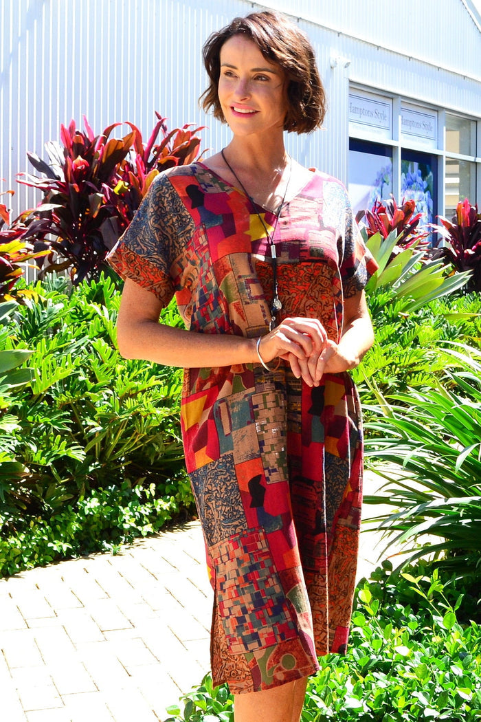 Rust orange playful tunic dress by Hourglass, featuring a relaxed fit and stylish design, displayed on a hanger.