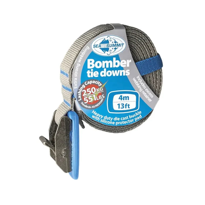 Sea To Summit 4 metre blue coloured Bomber Tie Down Strap coiled showing the silcone protection pad on a white background