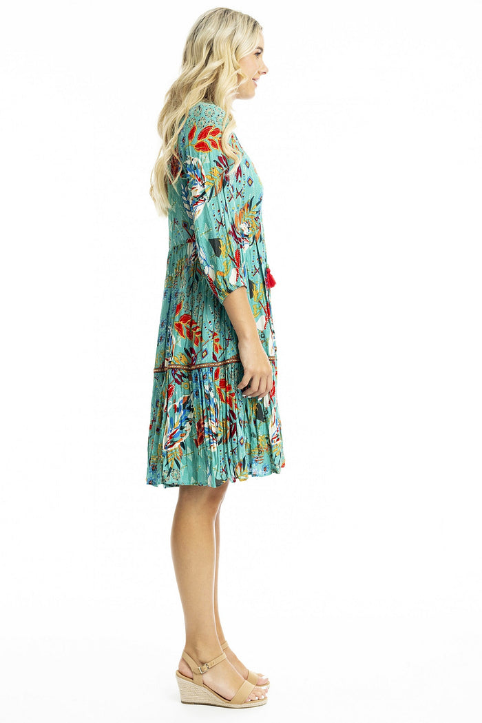 Orientique Serengetti V-neckline trim tunic dress, lightweight and stylish, shown hanging with detailed neckline and relaxed fit.