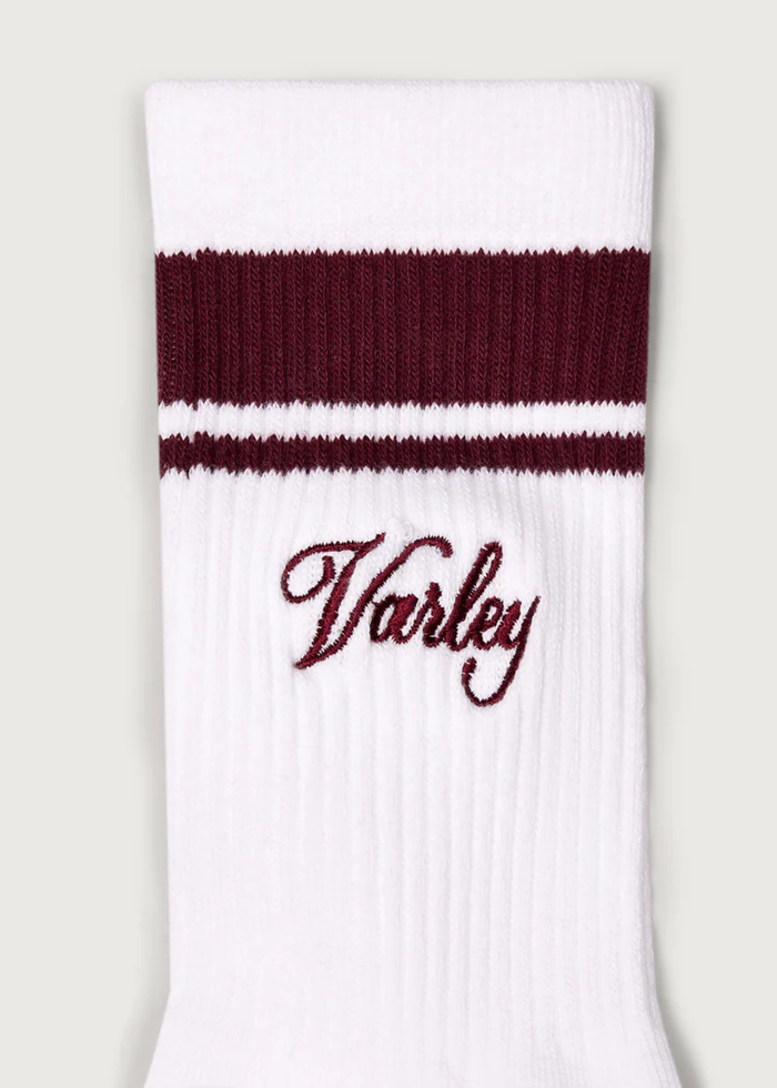 White crew socks with brown stripes and Varley logo