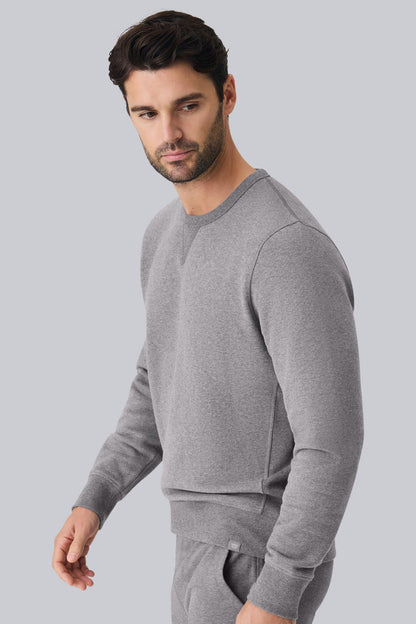Side view of a man wearing ACE Crew Neck Sweatshirt in Grey Heather