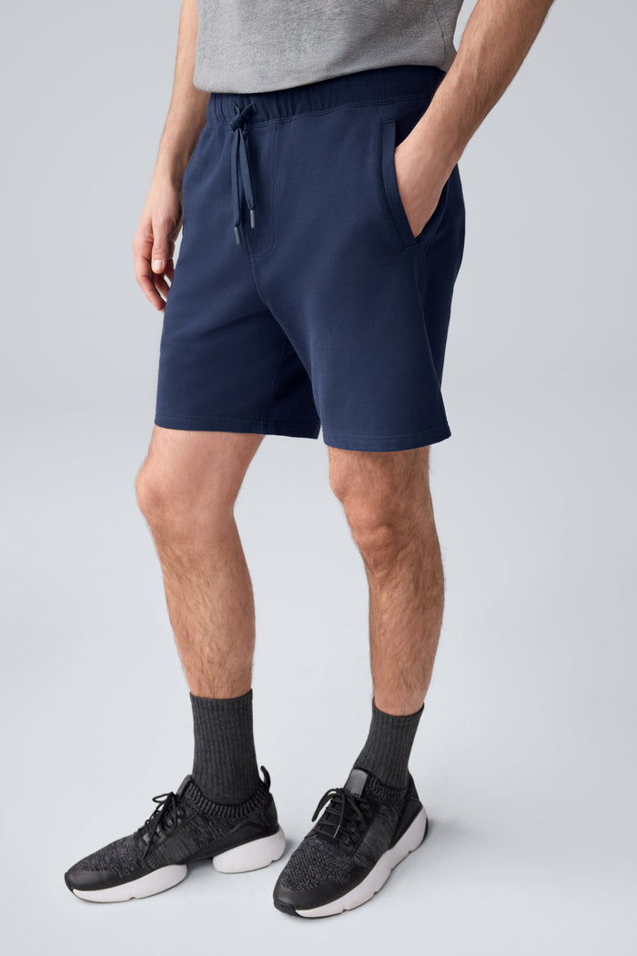 Side view of a man wearing ACE Sweatshort 7” in Total Eclipse