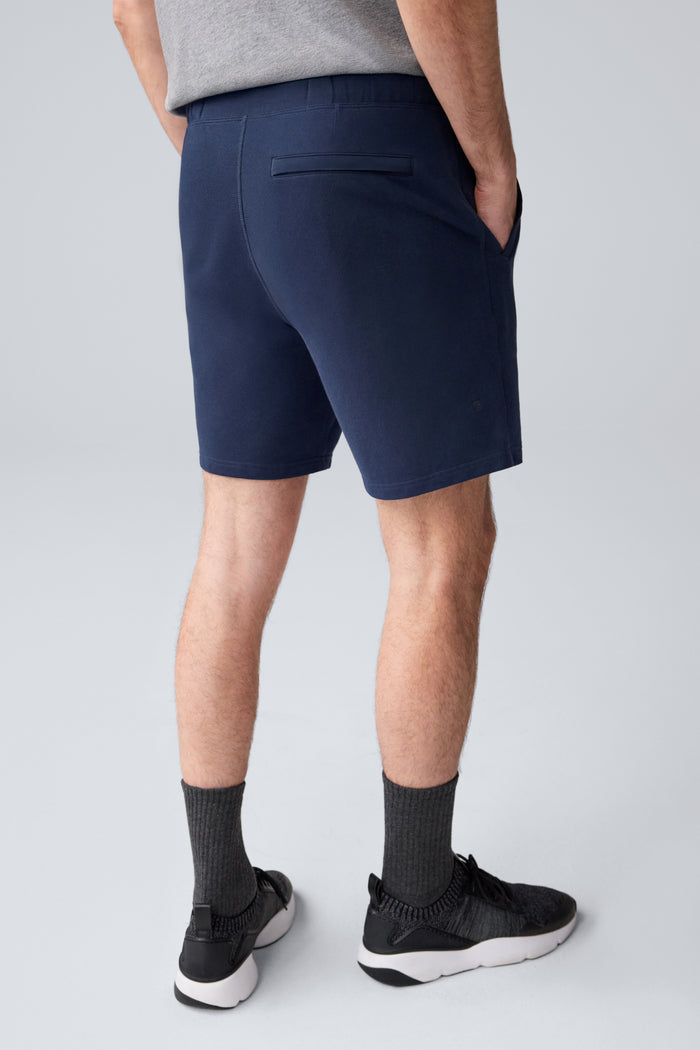 Back view of a man wearing ACE Sweatshort 7” in Total Eclipse