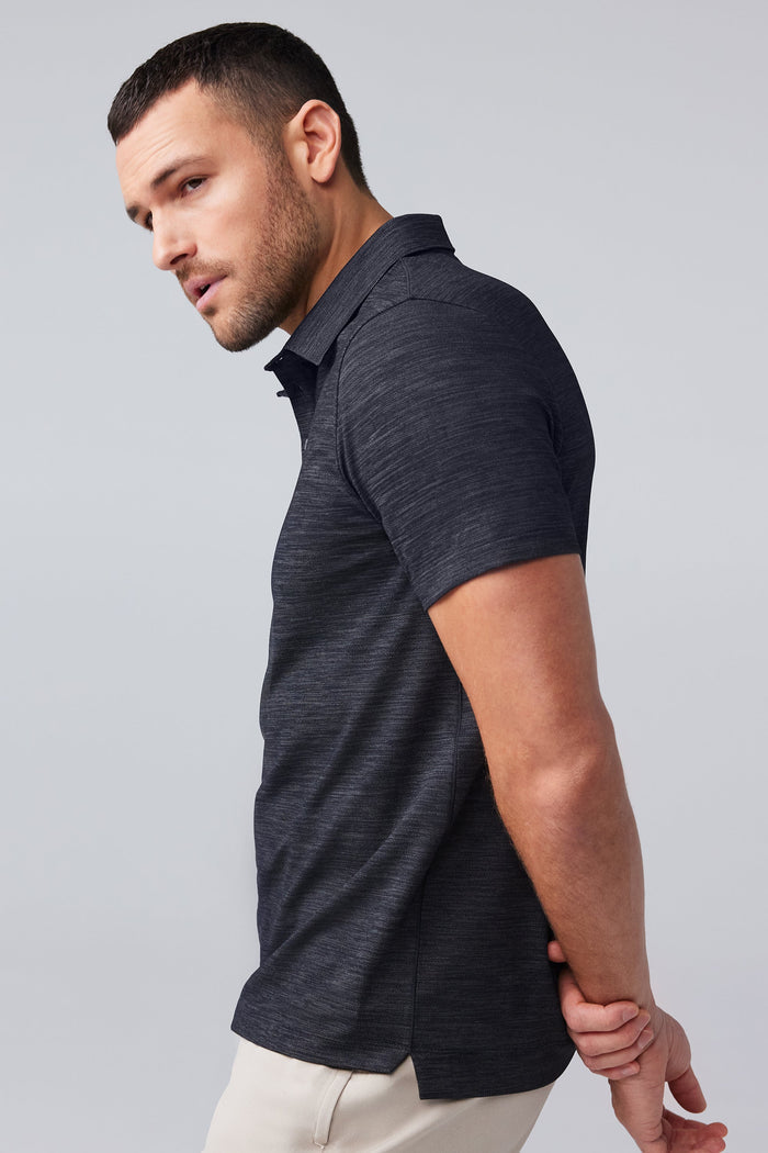 Side view of man wearing AIRKNITˣ Polo in Anthracite Gargoyle