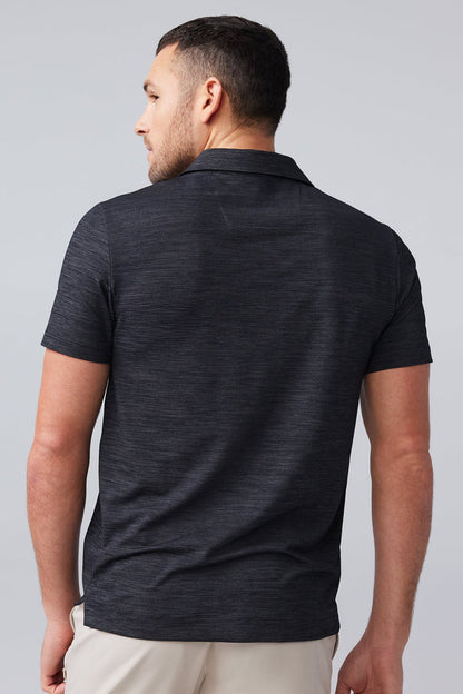 Back view of man wearing AIRKNITˣ Polo in Anthracite Gargoyle
