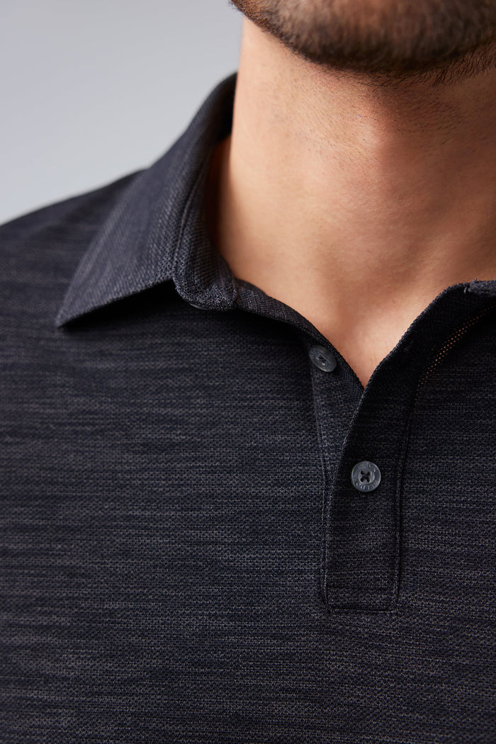 Close up view of man wearing AIRKNITˣ Polo in Anthracite Gargoyle