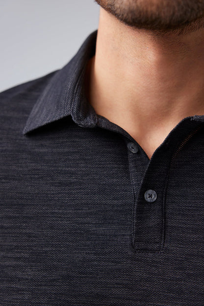 Close up view of man wearing AIRKNITˣ Polo in Anthracite Gargoyle