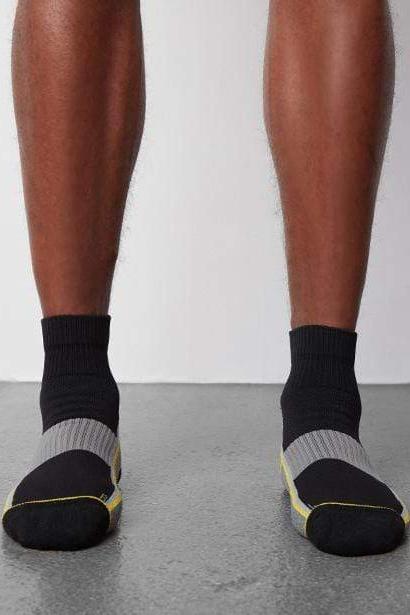 hover | Front view of a man wearing AIRKNITx High Ankle Sock in True Black /Taxi