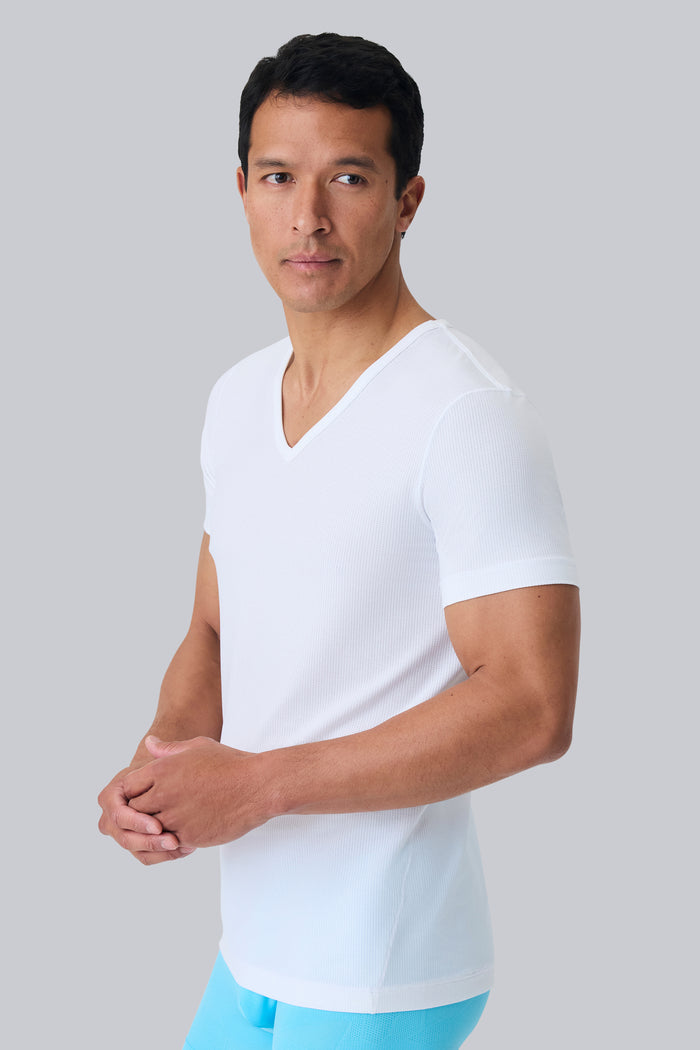 Side view of a man wearing AIRKNITˣ V-Neck Undershirt in Bright White