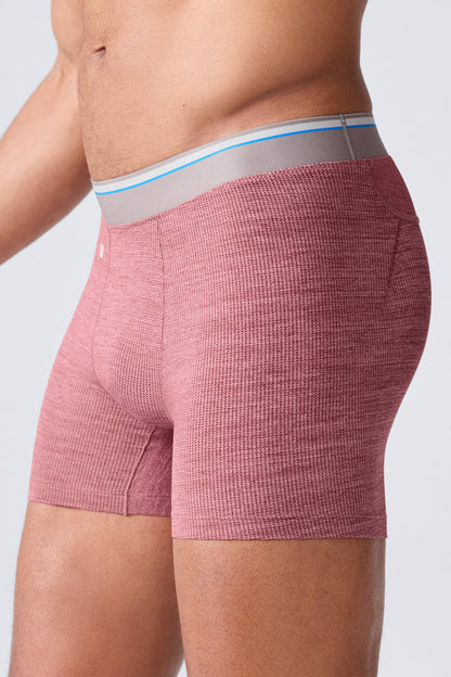 Side view of a man wearing Airknitx Boxer brief in Aged Port Heather