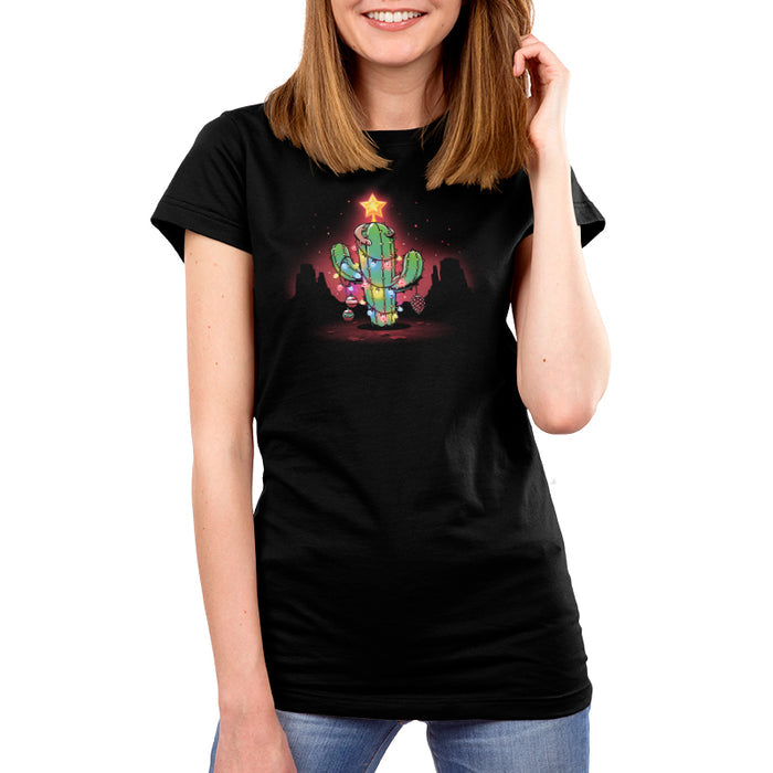 Premium Cotton T-shirt_TeeTurtle A Desert Christmas Black apparel featuring an artistic cactus with lights, ornaments, a star, and a gecko on top in front of a grand canyon inspired silhouetted background.