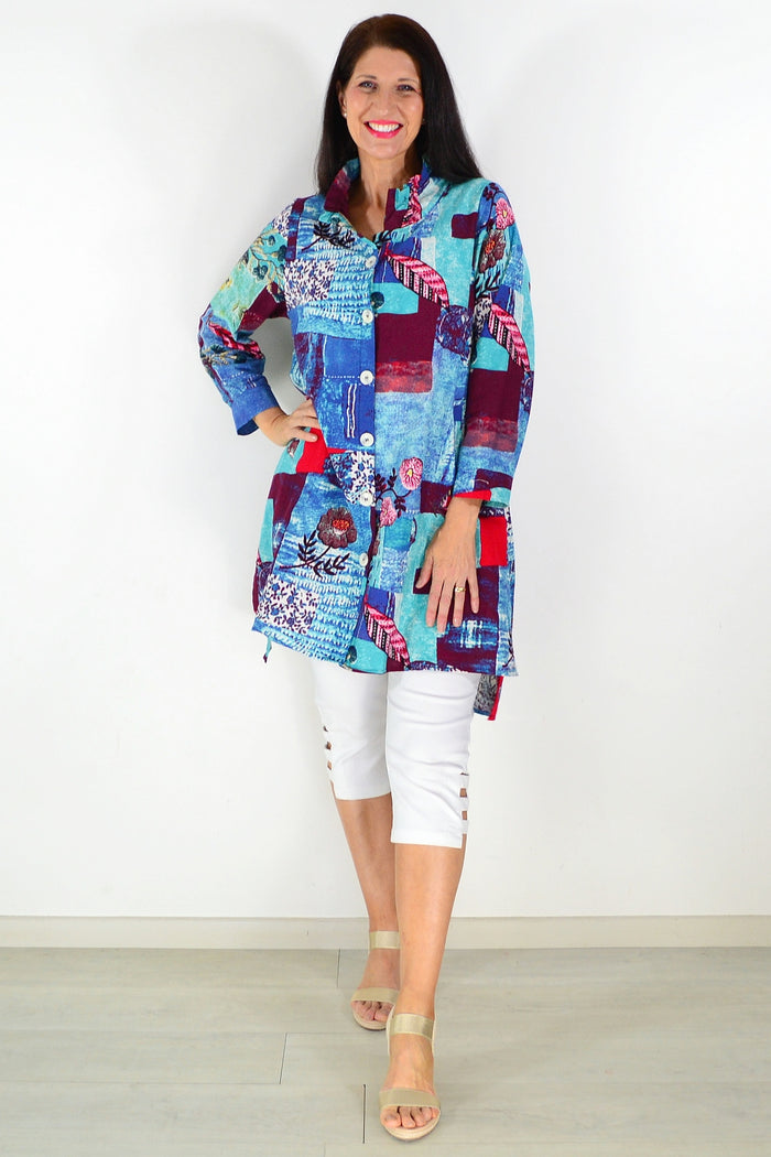 Abstract blue wishstone tunic shirt with loose fit and long sleeves, featuring a vibrant, artistic pattern on lightweight fabric.