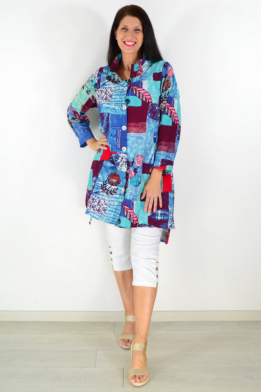 Abstract blue wishstone tunic shirt with loose fit and long sleeves, featuring a vibrant, artistic pattern on lightweight fabric.