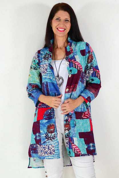 Blue abstract pattern tunic shirt by wishstone, featuring a relaxed fit and stylish design, displayed on a hanger.