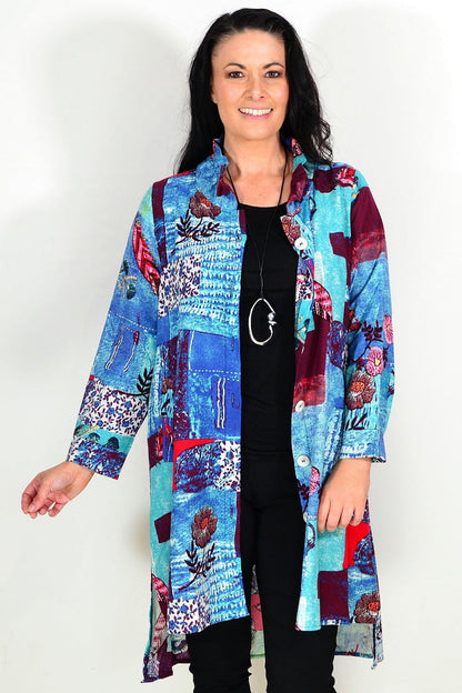 Abstract blue wishstone tunic shirt with flowing fabric and relaxed fit, displayed on a hanger.