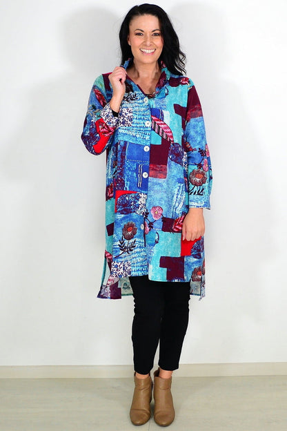 Abstract blue tunic shirt by Wishstone, featuring a relaxed fit and artistic design, displayed on a hanger in the image.