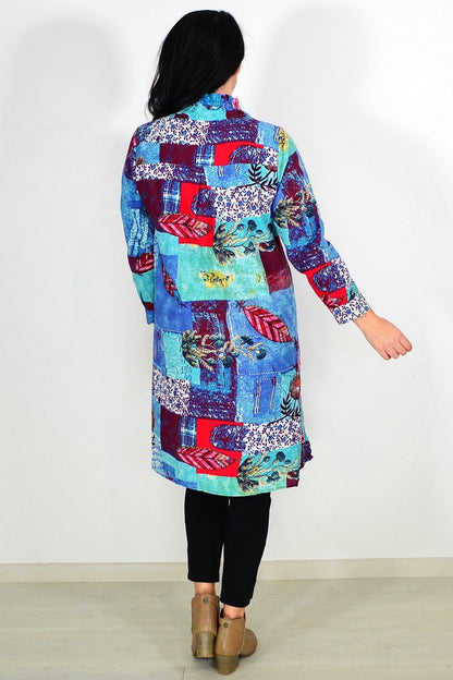 Abstract blue wishstone tunic shirt displayed on a hanger with flowing fabric and casual style.