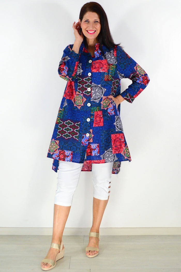 Abstract navy tunic shirt by Wishstone, featuring a loose fit and stylish design, displayed on a hanger against a plain background.
