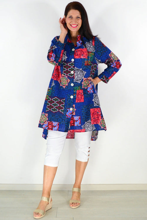Abstract navy tunic shirt by Wishstone, featuring a loose fit and stylish design, displayed on a hanger against a plain background.