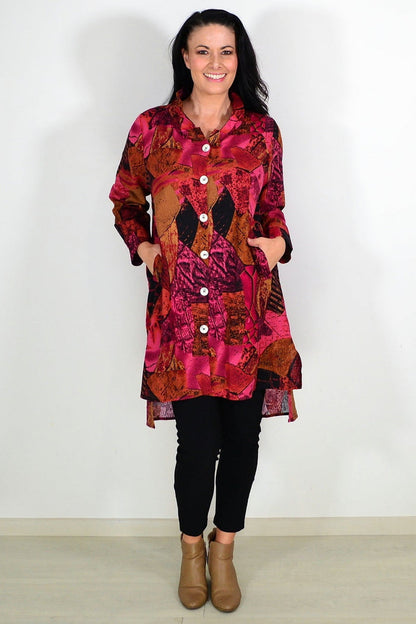 Pink mustard abstract tunic shirt by Wishstone, featuring a stylish pattern and relaxed fit, displayed on a hanger.