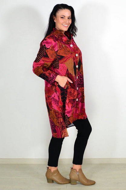 Abstract pink and mustard tunic shirt by Wishstone, featuring loose fit and stylish design, displayed on a hanger.