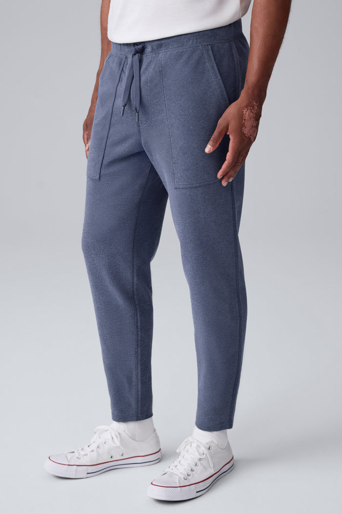 Side view of a man wearing Ace Carpenter Sweatpant in Navy Heather