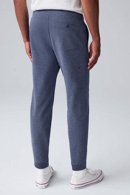 Back view of a man wearing Ace Carpenter Sweatpant in Navy Heather