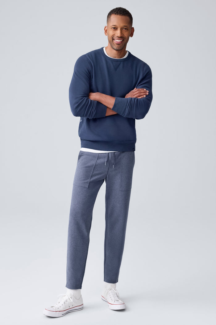 Full front view of a man wearing Ace Carpenter Sweatpant in Navy Heather