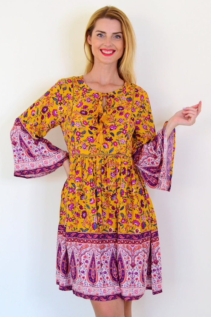 Dream Amelia Mustard Bohemian Tunic Dress with relaxed fit and floral patterns, featuring a V-neck and long sleeves.