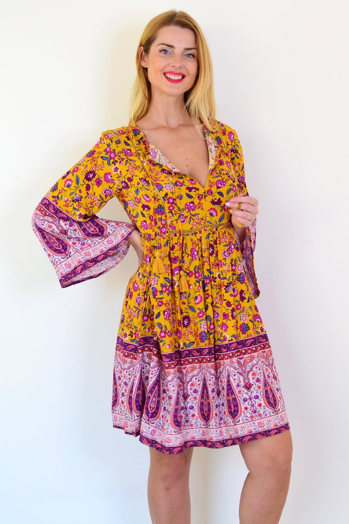 Dream Amelia Mustard Bohemian tunic dress featuring flowy fabric and boho-inspired design, shown in a stylish outdoor setting.