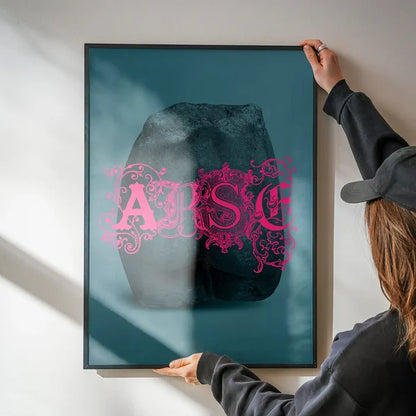 Arse Sculpture Pink Print being hung on a wall in a black frame