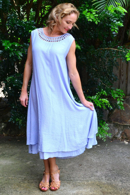 Baby blue Grecian sleeveless tunic dress by La Mode, featuring flowing fabric and elegant design, shown on a dress form.