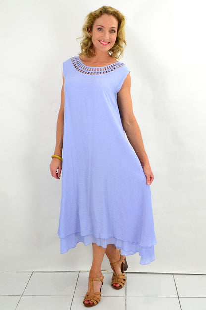 Baby blue La Mode Grecian sleeveless tunic dress with draped fabric and flowing silhouette, displayed on a mannequin.