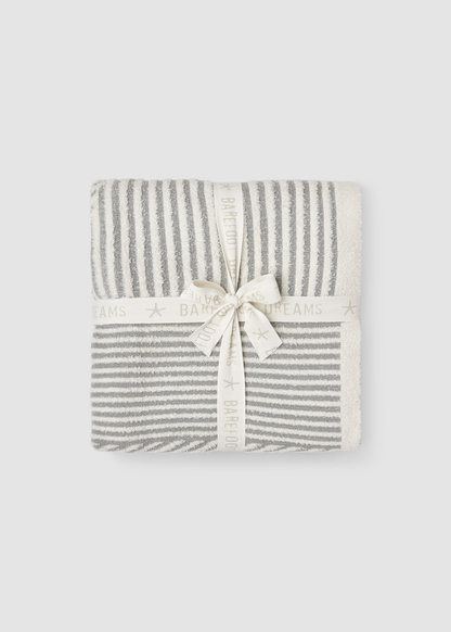 Grey and white striped blanket folded and tied with a white bow