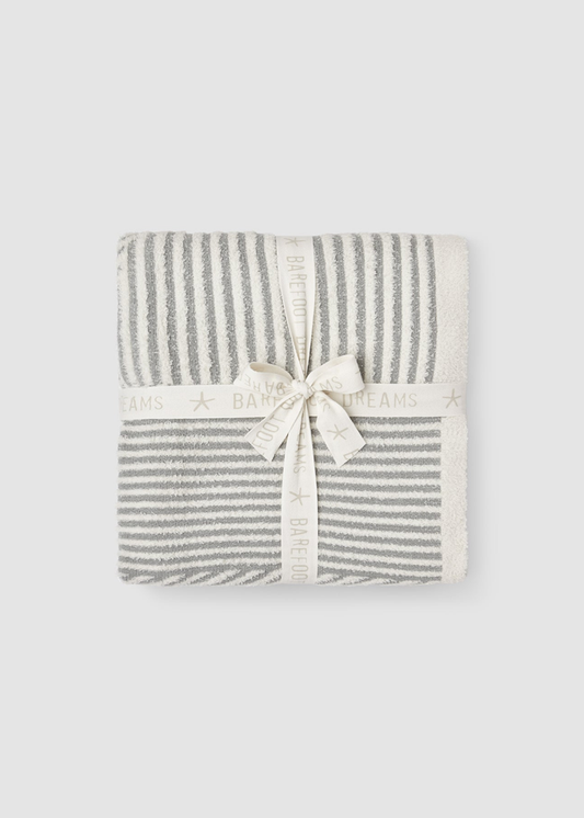 Grey and white striped blanket folded and tied with a white bow