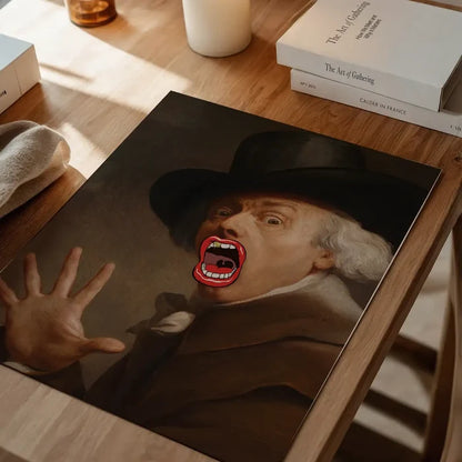 Bigmouth Gold Tooth Altered Art Print, quirky altered art print unframed on a home office desk