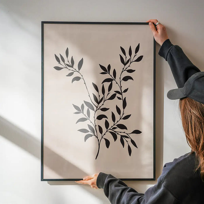 Branch Silhouette Print 2 being hung on a wall in a black frame
