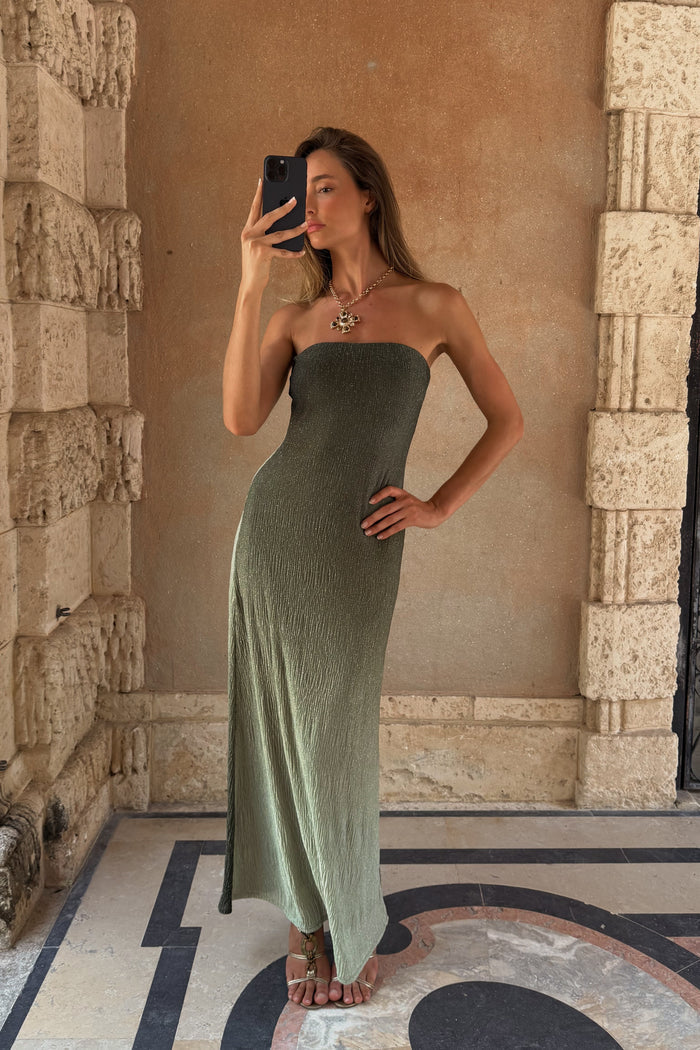 Mirror selfie in a shimmery sage ombre strapless maxi dress against a stucco resort wall.