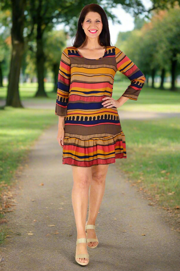 Brown Swirls Tunic Dress by Hourglass featuring a flowing silhouette and swirling pattern, displayed on a hanger.