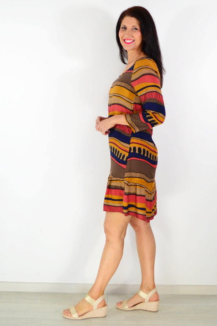 Brown Swirls Tunic Dress by Hourglass, featuring a flowing fabric with swirling pattern, displayed on a hanger.