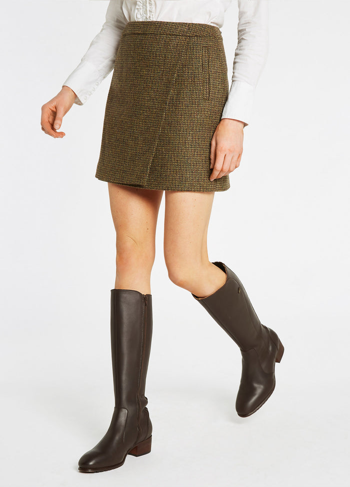 A below wait on model image of the Dubarry women's Buckthorn Tweed Heath Skirt with zip at the back and two functional welted front pockets