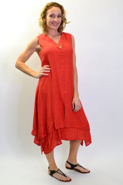Burnt orange sleeveless button tunic dress from La Mode, shown hanging on a wooden hanger with a simple backdrop.