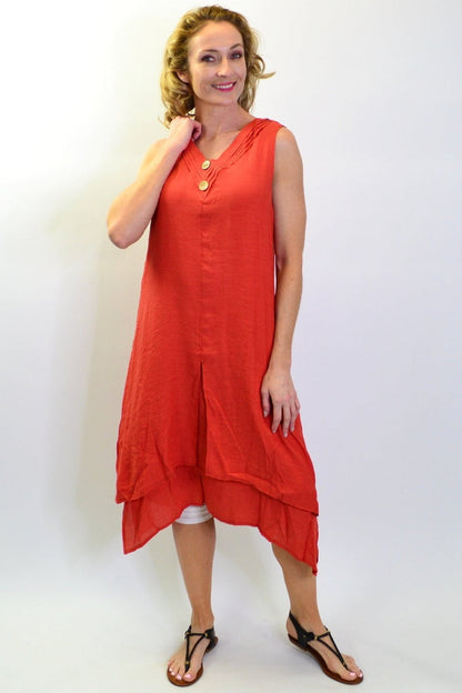 Burnt orange sleeveless button tunic dress by La Mode hanging on a wooden hanger, showcasing its sleeveless design and button details.