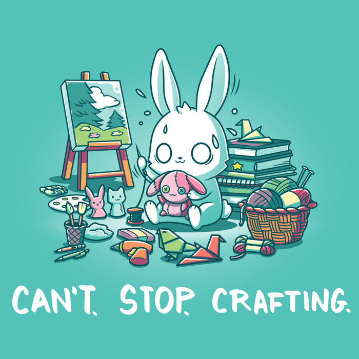 Premium Cotton T-shirt_TeeTurtle Can't. Stop. Crafting. Caribbean blue t-shirt featuring an illustration of a white rabbit with large, expressive eyes, and sweat droplets coming from its head sewing a small pink bunny surrounded by crafting materials like balls of yarn in a woven basket, paint pallets and brushes,  origami birds and other shapes, sewing thread, small stuffed animals, books stacked high, craft knives, and other crafting supplies, with the text "CAN'T. STOP. CRAFTING." at the bott