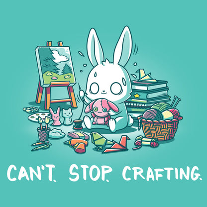 Premium Cotton T-shirt_TeeTurtle Can't. Stop. Crafting. Caribbean blue t-shirt featuring an illustration of a white rabbit with large, expressive eyes, and sweat droplets coming from its head sewing a small pink bunny surrounded by crafting materials like balls of yarn in a woven basket, paint pallets and brushes,  origami birds and other shapes, sewing thread, small stuffed animals, books stacked high, craft knives, and other crafting supplies, with the text "CAN'T. STOP. CRAFTING." at the bott