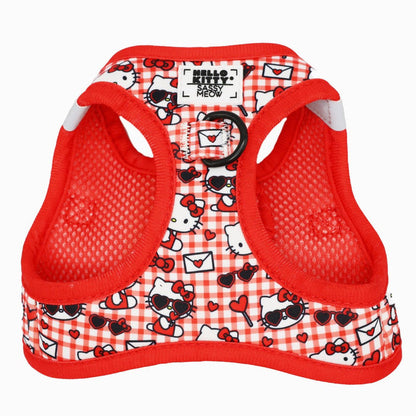 The Sassy Woof Cat Bundle - Hello Kitty® Red Classic features a red and white plaid mesh harness with Hello Kitty faces, hearts, and sunglasses, plus a black D-ring and “Sassy Meow” tag—ideal for fans of adjustable pet gear.