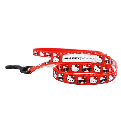 The Cat Bundle - Hello Kitty® Red Classic by Sassy Woof is a red adjustable pet leash decorated with Hello Kitty faces in red bows and finished with a black metal clasp.